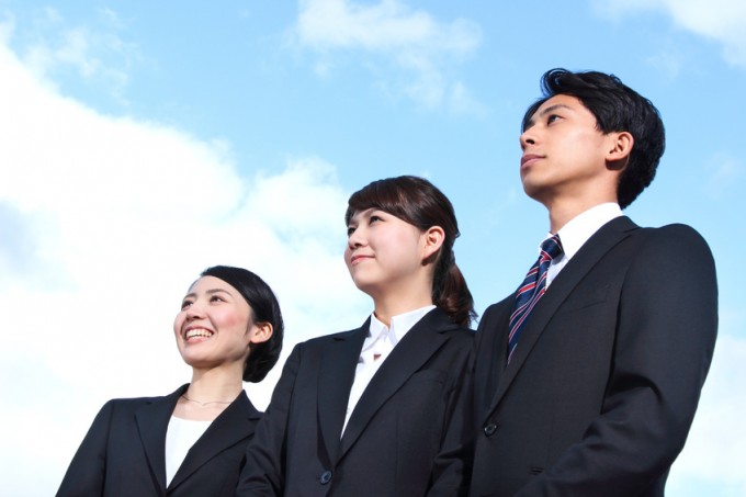 Asian businessman and businesswoman looking up at the sky